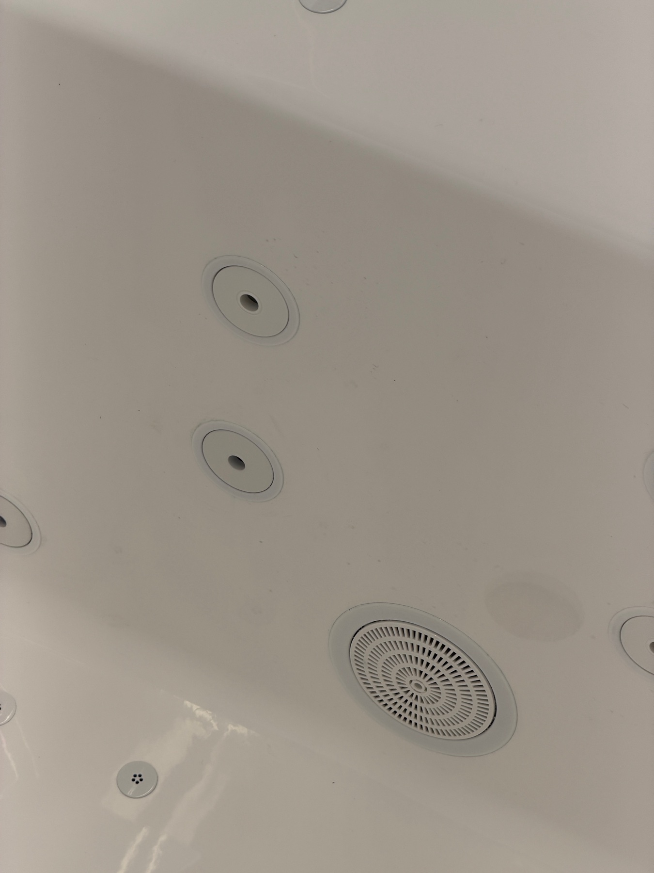 Flush whirlpool jets plated white to match the tub